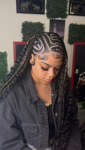 Taloria Clark gives a client Bohemian tribal braids at Queens Beauty Bar in Winterville. Clark specialises in knotless, stitch and box braids. She also does locs, retwists, quick weave, sew-ins and wigs. (Photo Submitted)
