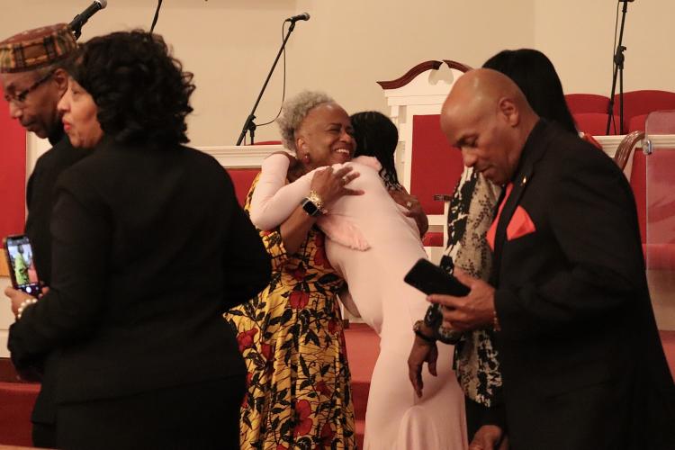 Monica Kaufman Pearson (left) and Bonnie Sims share a hug following the Inaugural Black History Collaborative on Sunday. The event took place at Thankful Baptist Church on Union Point Rd. (Photo/Mia Tanner)