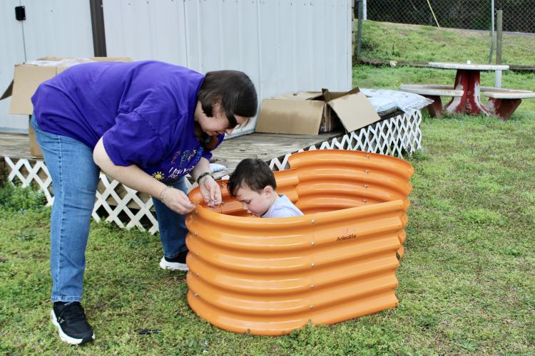 Satilla Mathews, a teacher at Oglethorpe Children’s Academy, and student Riggin Liedberg put together a bed in the school’s STEM garden. OCA has received funding for four of the five grants that Mathews applied for last year. (SARAH OWENS/THE OGLETHORPE ECHO)