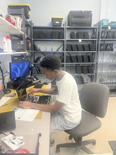 Victor Ross works repairing the keyboard on a school laptop during his internship in the Oglethorpe County High School's IT department after school on Feb. 12, 2026. He usually works during his seventh period, and this internship has helped him see himself in a computer science-related career. (Photo/Eva Saraf)