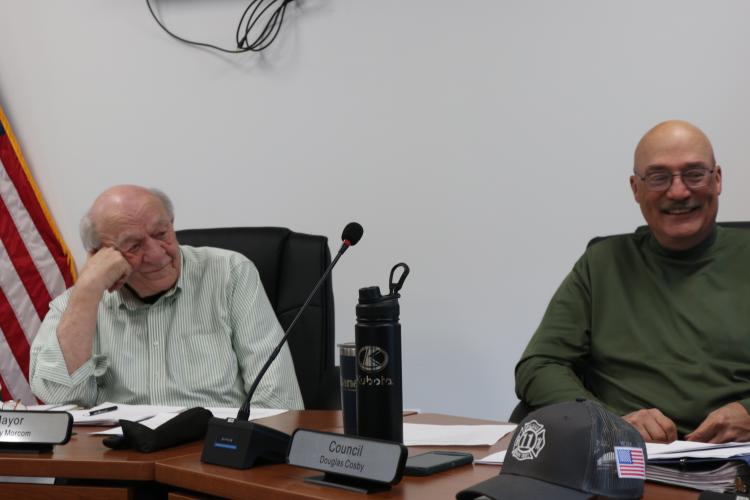 Arnoldsville Mayor Danny Morcom (left) and council member Douglas Cosby (right) chat before the city council meeting on March 19. Over ten people attended this meeting. (Photo/Jessie Isaacs)