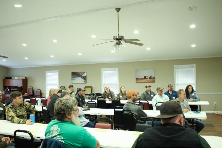 Attendees listen as D.D. Quillian speaks during the Wild Turkey Hunting Seminar at the Oglethorpe County Farm Bureau on Saturday. More than 20 people attended the seminar. (Dakota Meeks/The Oglethorpe Echo)