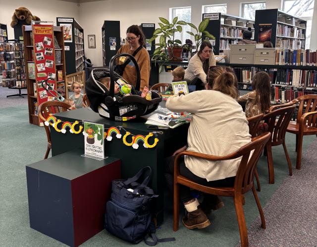 Moms and their children work on crafts at the St. Patrick’s Day celebration at the Oglethorpe County Library on March 17. The events are planned with various activities to accommodate children of different ages and abilities. (CHARLOTTE COCHRAN/ THE OGLETHORPE ECHO)