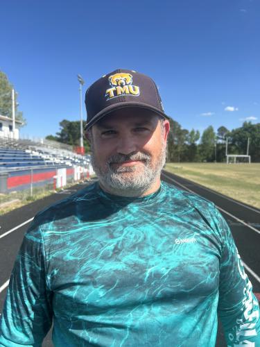 Brandon Adams, a middle school teacher and head coach of varsity cross country, discussed the development of a new cross country course at Oglethorpe County. The course, unique for its all-grass surfaces and challenging hills, aims to better prepare athletes for state competitions. (Photo/Grant Turnage)