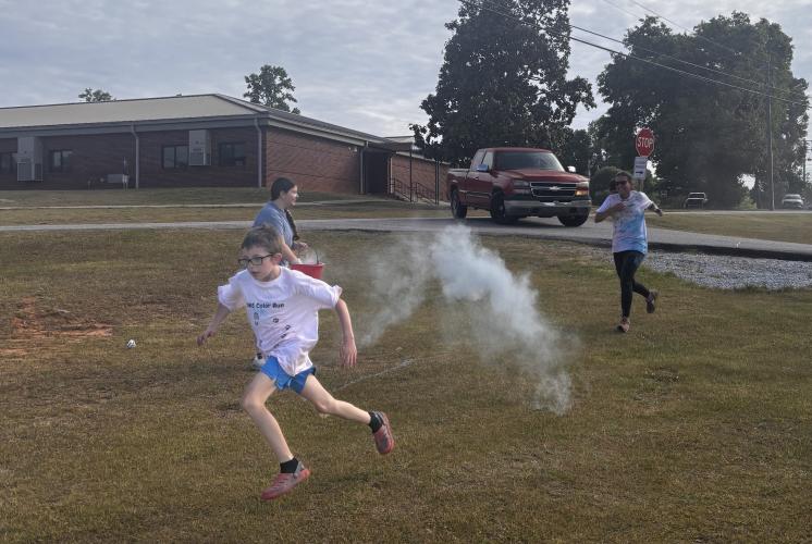 Henry Kitchen races toward the finish line at the OCHS National Honor Society Color Fun Run on April 25. Proceeds from the Color Fun Run benefitted the Madison Oglethorpe Animal Shelter. (CHARLOTTE COCHRAN/THE OGLETHORPE ECHO)