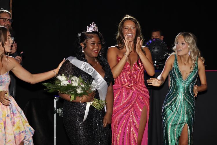 Za’Nijha Carter soaks in the moment after being named queen of the Oglethorpe County High School prom on April 18 at Historic Smithonia Farm. Fellow seniors Elizabeth Cook and Peyton Lewis congratulate Carter. (Photo/Mia Tanner)