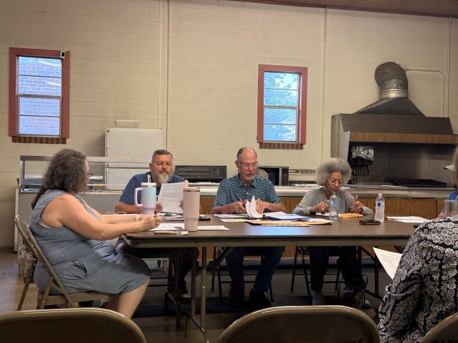 Maxeys council members review documents during the city’s April meeting on April 14 at Maxeys City Hall. (Photo/Riley Baugh)