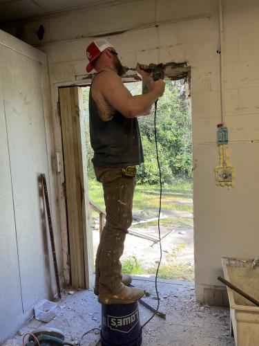 Travis Hill, owner of Hill Renovations, rebuilds the back door at The Local Spot. Hill's business is contracted to do all renovations for the restaurant. (Photo Submitted)