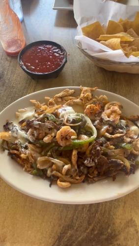 La Cabaña de Don Juan offers a variety of Mexican cuisine. The picture shows the 'Arroz Texano', steak, chicken, shrimp, bell peppers, onions, tomatoes and rice topped with queso. (Finley Millwood/The Oglethorpe Echo)