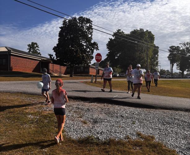 Race participants approach the finish line at the OCHS National Honor Society Color Fun Run, on April 25, 2026. Some participants ran, while others walked the 1.5 mile path laid out by student volunteers and members of the National Honor Society. (CHARLOTTE COCHRAN/ THE OGLETHORPE ECHO)