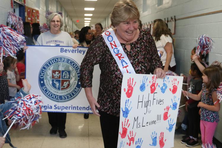 Oglethorpe County school superintendent Beverley Levine greets students while walking through the hallways of Oglethorpe County Elementary School on Thursday, Oct. 20, 2022 in Crawford, Georgia. In response to the Levine being named one of four finalists for the Superintendent of the Year award at the state level, all three schools in Oglethorpe County surprised Levine with a parade-like celebration at each school. (Katie Tucker/The Oglethorpe Echo)