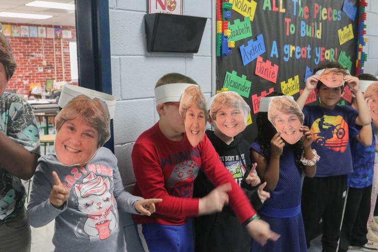 Oglethorpe County Elementary School students wear masks of Oglethorpe County school superintendent Beverley Levine's face on Thursday, Oct. 20, 2022 at Oglethorpe County Elementary School in Crawford, Georgia. In response to the Levine being named one of four finalists for the Superintendent of the Year award at the state level, all three schools in Oglethorpe County surprised Levine with a parade-like celebration at each school. (Katie Tucker/The Oglethorpe Echo)