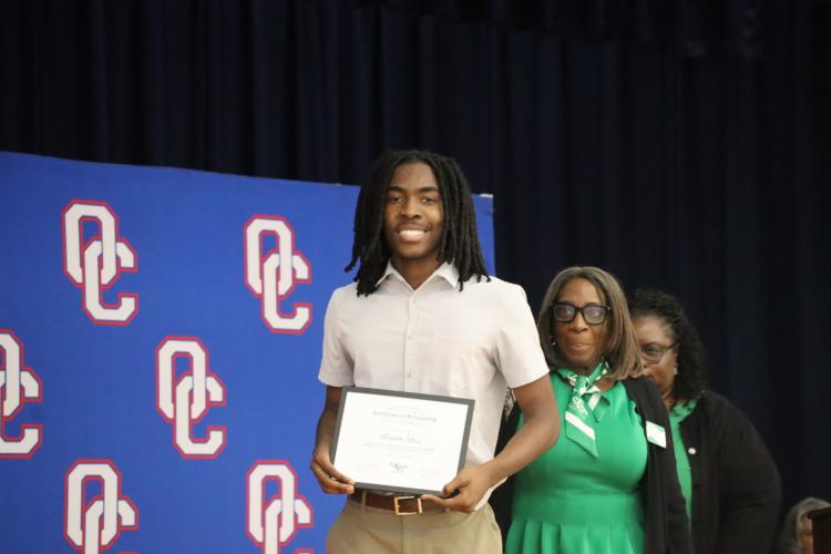 Senior, Isaiah Ross standing on stage at OCHS senior honors night, after receiving The Links, Inc., Athens Chapter Scholarship. (Ellie English/The Oglethorpe Echo)