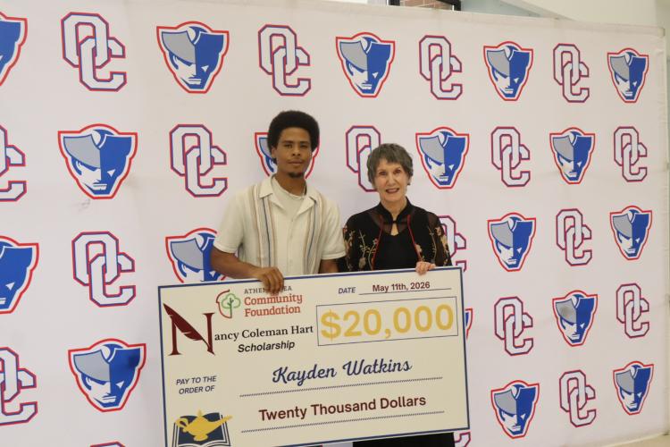 Kayden Watkins (left) stands with his $20,000 check from Dr. Nancy Coleman Hart (right) Scholarship. (Ellie English/The Oglethorpe Echo)