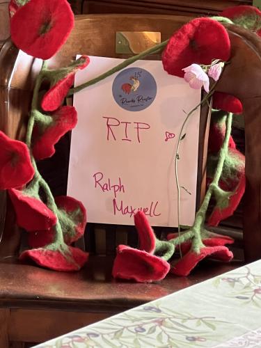 Ralph Maxwell Jr.’s chair — it has his name on it —  at The Rowdy Rooster has been adorned with a note and flowers. (Submitted Photo)