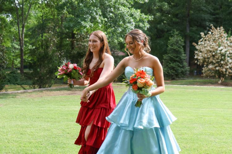 Andee Dellinger  and Carlie Gabriel walk across the yard for photos before prom in Oglethorpe County on Saturday, April 18, 2026. (Addison Simmons/The Oglethorpe Echo)