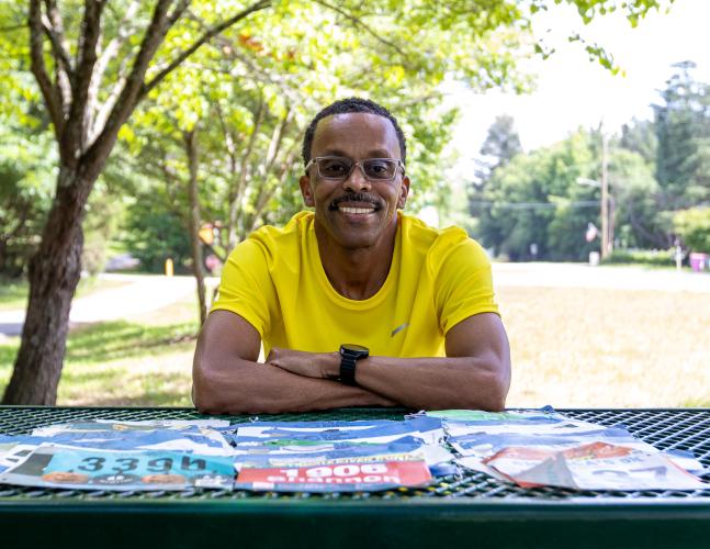 Crawford resident Shannon Arnold poses for a portrait with his running bibs in Maxeys on June 8, 2026.  Arnold placed third in the Maxeys Model Mile 5K in May and will compete in the National Senior Games in Tulsa, Oklahoma, in July. (Ethan Greene/The Oglethorpe Echo)