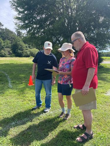 Jay Swaims (from left), Mary Ann Paganella and TJ Alexander decide which Jeep will take home an award during Town and Country Kafe's Jeep Invasion. The competition featured categories like Best Classic Jeep, Best Custom Build and Crowd Favorite. (Lexie Shadix/The Oglethorpe Echo)