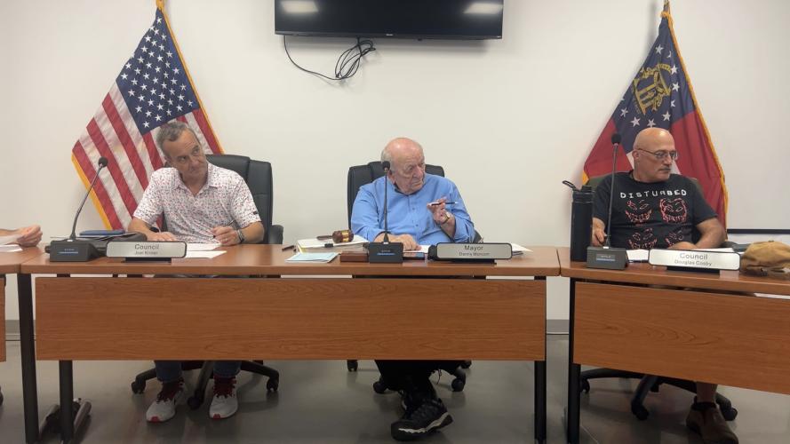 Mayor Danny Morcom and members of the Arnoldsville City Council — Joel Kriner (left) and Douglas Cosby (right) — discuss city business at this month’s meeting on June 18. Arnoldsville’s water tanks are full, due to the recent rainfall. (Jessie Isaacs/The Oglethorpe Echo)