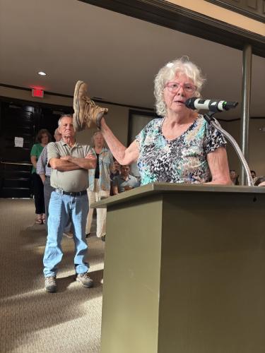 Betsey Collins, who lives on Old Edwards Road, used an old boot for an analogy while voicing her opposition to the proposed rezoning of 108 acres near Yancey Road and Highway 78.  (Andy Johnston/The Oglethorpe Echo)