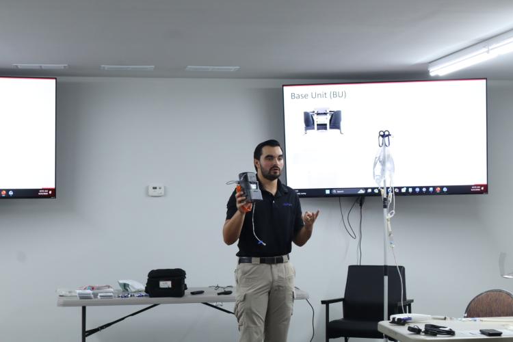 Tate Rodriguez demonstrates a QinFlow warmer device during a prehospital blood administration training course for Oglethorpe County EMS personnel on Tuesday. The training is required for the county’s whole blood program. (Ellie English/The Oglethorpe Echo)