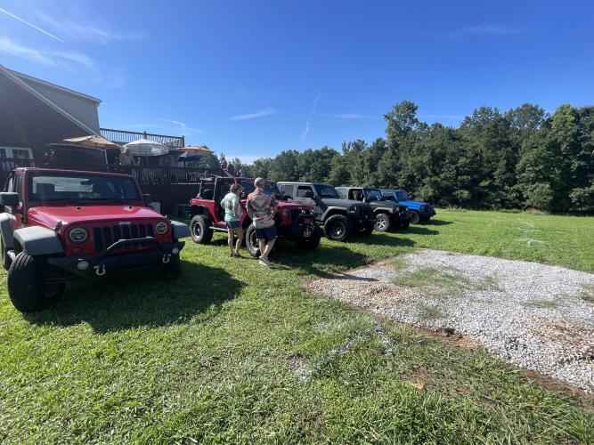 Attendees of Town and Country Kafe’s Jeep Invasion look at the Jeeps on display. About a dozen Jeeps were parked outside the cafe during the event on June 20. (Lexie Shadix/The Oglethorpe Echo)