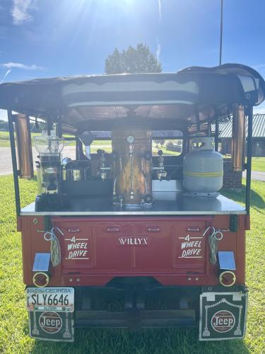 Willie Torres can craft an espresso at the back of his 1954 Willys Jeep. A gift from his wife, the Jeep inspired Town and Country Kafe's first Jeep Invasion event. (Lexie Shadix/The Oglethorpe Echo)