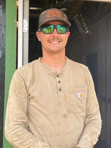 Ethan Allen poses for a picture outside the new building that is being added to the Arnoldsville Fire Department. Allen is the contractor working on the addition, and expects the work to be done sometime next month. (Lexie Shadix/The Oglethorpe Echo)