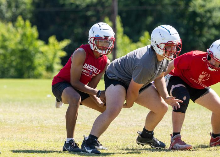 OCHS quarterback Nathan McCalla takes a snap during spring practice. He’s expected to share quarterback duties with junior Justin Wilson this season. (Ethan Greene/The Oglethorpe Echo)