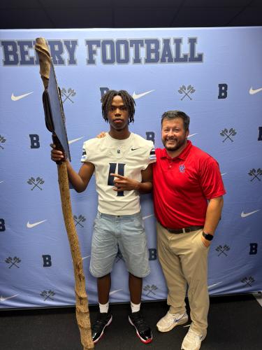 Nicah Pass (left) holds a prop with Oglethorpe County head coach Michael Holland while on a recruiting visit to Berry College in Rome this summer. Pass, a defensive back/receiver, has been invited by Berry to attend a game this fall. (Submitted Photo)