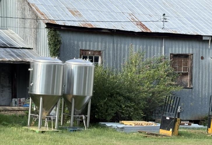 Glynn Segars, who owns Community Cigar, is storing vats outside his warehouse in downtown Lexington. The vats were from Jekyll Brewing, which closed its locations in 2025. (Dink NeSmith/The Oglethorpe Echo)
