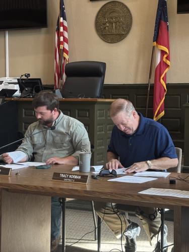 Commissioners Will Brown (left) and Tracy Norman look over paperwork at the start of the Board of Commissioners meeting on Monday at the courthouse. At Norman’s suggestion, the board approved a 90-day moratorium on data center applications. (Andy Johnston/The Oglethorpe Echo)