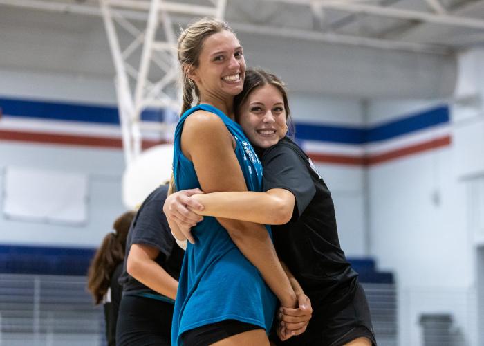 Oglethorpe County sophomore Naomi McPeake, in black, hugs junior Leanna Newton during practice at Oglethorpe County High School in Lexington on Friday, July 31, 2026. (Ethan Greene/The Oglethorpe Echo)