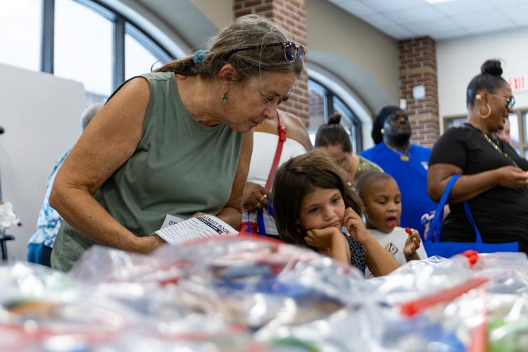 Attendees walk among tables at Oglethorpe County Community Day hosted by Family Connection at Oglethorpe County Middle School in Lexington, Georgia, on Saturday, Aug. 8, 2026. (Ethan Greene/The Oglethorpe Echo)