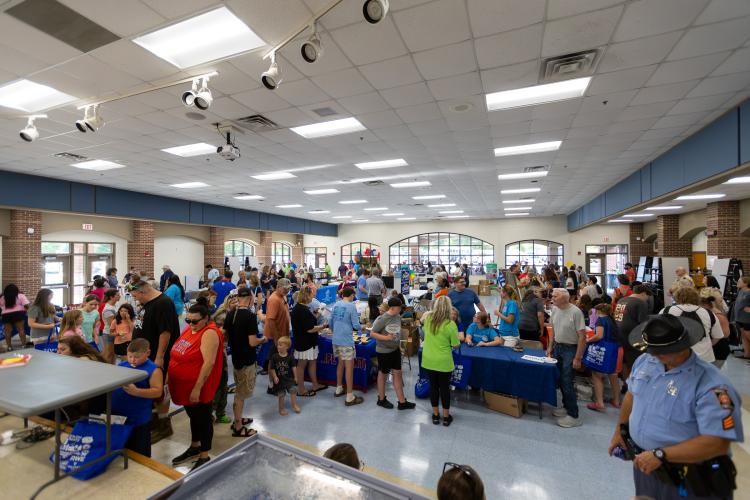 Attendees walk among tables at Oglethorpe County’s annual Community Day, which was presented at Oglethorpe County Middle School on Saturday. There were 51 businesses, churches, vendors and organizations represented, which set a record. (Ethan Greene/The Oglethorpe Echo)