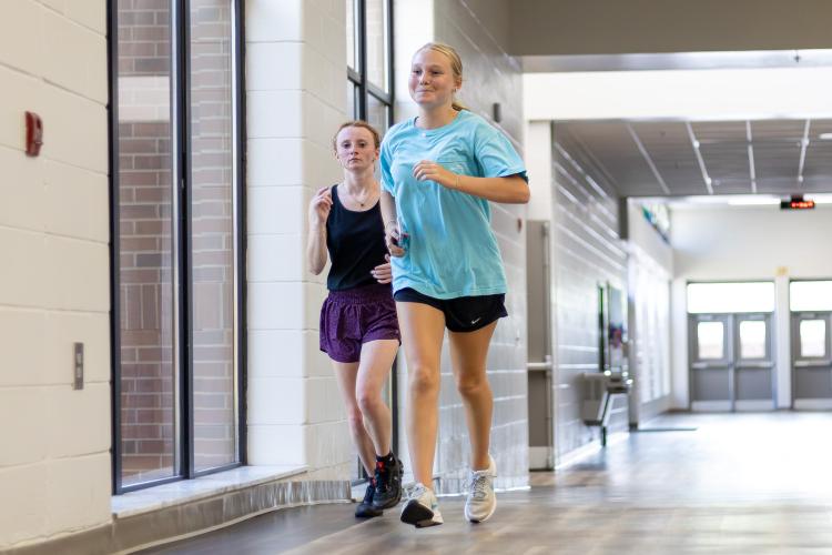 Maleah Booth, left, and Reagan Turner, right, practice with the cross country team on Monday, Aug. 17. 2026. Much of the team's fall practices have been indoors due to high temperatures and humidity. (Ethan Greene/The Oglethorpe Echo)