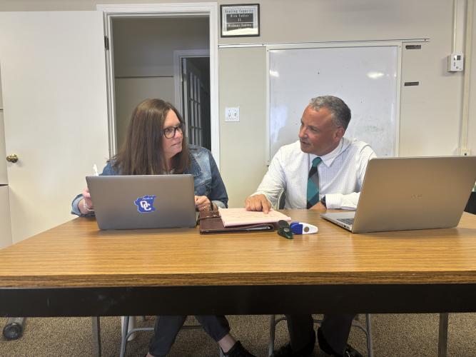 Karyn Gunter (left), the director of special education and student support, confers with Oglethorpe County School Superintendent Phillip Powell during a meeting on July 20. Powell will hold a community feedback time on Saturday. (Andy Johnston/The Oglethorpe Echo)