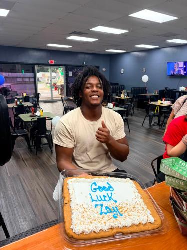 Former OCHS and Athens Academy running back PayTon Xavier “Zay” Prince celebrates at his send-off party with a cookie cake at The Local Spot in Crawford on July 28. He has signed to play football at the University of the Cumberlands. (Submitted Photo)