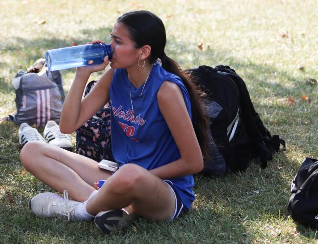Senior Margarita Rodriguez-Valdez drinks water after cross country practice at OCHS on Friday. Athletes are encouraged to stay hydrated in order to prevent heat exhaustion and dehydration amid high temperatures. (SYDNEY JARRARD/THE OGLETHORPE ECHO)