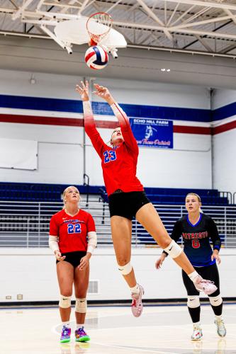 Naomi McPeake skies for a shot in front of teammates Azalee Ring (22) and Hayley Matthews during a recent match at OCHS. The Patriots play Jackson County and Cedar Shoals at Cedar Shoals on Thursday. (Photo/Ty Johnston)