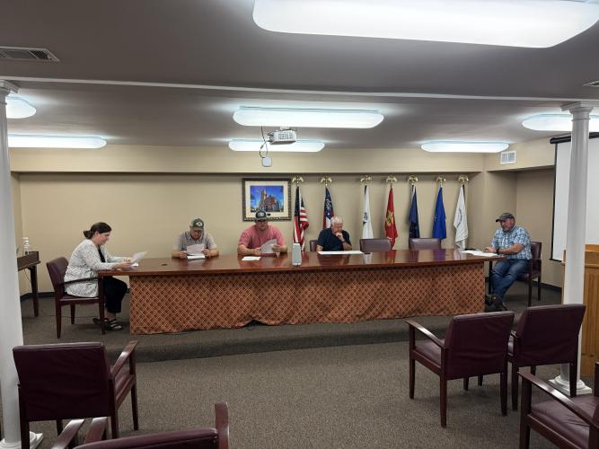 From left: board members Morgan Robinson, Sam Nash, JF Hansford and Jimmy Shealy. Jeff Sharp, the director of planning and zoning sits on the far right. The board reviews the minutes from the previous month's meeting. (Ren Grimsley/The Oglethorpe Echo)
