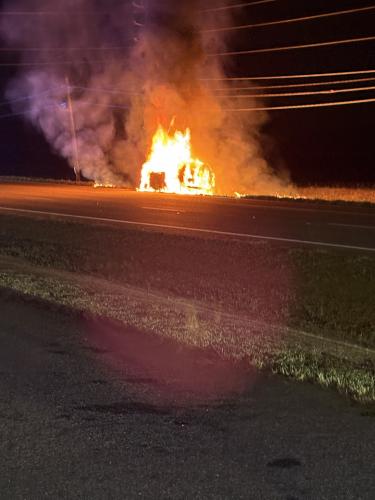 There were no reported injuries from a car fire next to a hay field along Highway 78 across from the Farm Bureau in Crawford on Friday night. Firefighters soaked the edge of the field to prevent the fire from spreading beyond the vehicle. (Submitted Photo)