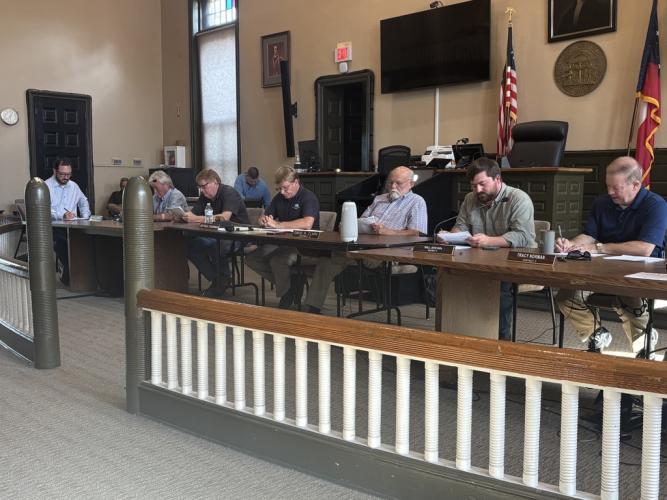 Jay Paul, chairman of the Board of Commissioners (fourth from right) and the commissioners look over the agenda at a recent meeting at the Oglethorpe County Courthouse. The board permanently moved its meetings to the courthouse in June. (ANDY JOHNSTON/THE OGLETHORPE ECHO)