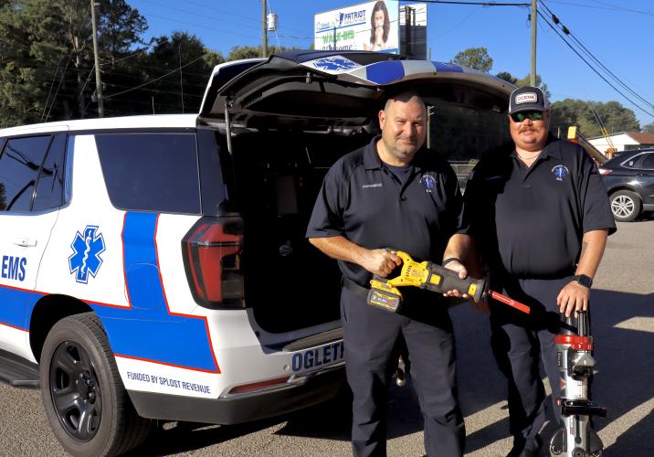 EMS paramedics Dennis Weaver (left) and Kelly Huff showcase a battery-powered extrication tool in front of the 2025 Chevy Tahoe. The equipment is part of a high-tech medical kit stocked inside the county’s new SPLOST-funded Quick Response Vehicles. (ISABELLA PANG/THE OGLETHORPE ECHO)
