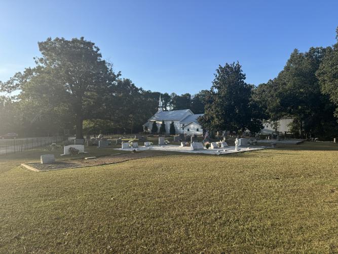 A wide view of a section of the cemetery at Temple Methodist Church in Arnoldsville, GA on Sept. 13, 2026. Julio Soto has performed tombstone restorations in the church's cemetery. (Sabrina Felix/The Oglethorpe Echo)