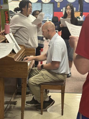 Lee Jones plays the piano as students practice a song in the Oglethorpe County High School music classroom last month. Jones has been the band and chorus director at OCHS for 13 years. (Sabrina Felix/The Oglethorpe Echo)