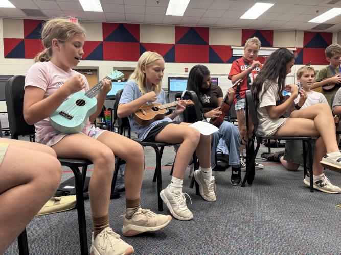 6th-grade students Elizabeth Tillman, Josie Turner, Sherlyn Vilchiz-Mendoza, Mariana Giardina and Lux Kuewa-Mokiao strum their ukuleles in class. The students at Oglethorpe County Middle School play nursery rhyme songs to learn basic chords (Photo/Walker Durham).