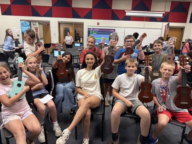 Students in the 6th-grade OCMS ukulele class pose with their string instruments. They learn basic strumming and chord patterns during the quarter. (Photo/Walker Durham).