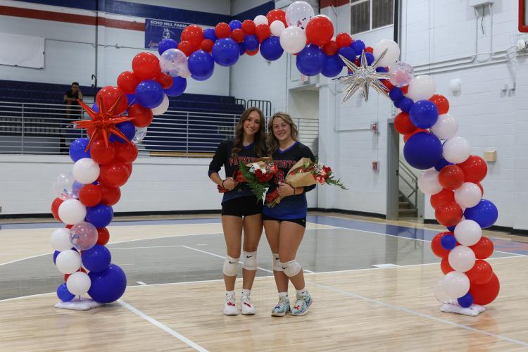 Nora Turner (left) and Haley Matthews were recognized on senior night for the OCHS volleyball team on Tuesday. East Jackson defeated the Patriots in five sets. (Wesley Webb/The Oglethorpe Echo)