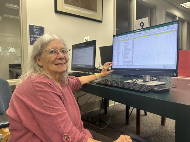Kathleen deMarrais, president of Historic Oglethorpe County, shows the obituary database that was compiled from copies of The Oglethorpe Echo at the Oglethorpe County Library. The database is a publicly available resource for genealogists, researchers and community members. (Photo/Caroline Feagin)